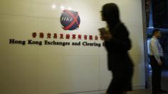 A staffer walks into the Hong Kong Stock Exchange in Hong Kong October 28, 2014.  REUTERS/Bobby Yip  