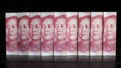 Chinese 100 yuan banknotes are seen in this picture illustration taken in Beijing July 11, 2013. REUTERS/Jason Lee