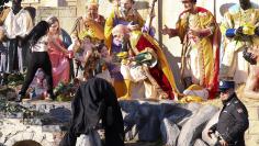 A Vatican gendarme attempts to block a topless activist of women's rights group Femen, who tries to reach the Nativity scene in Saint Peter's square in the Vatican