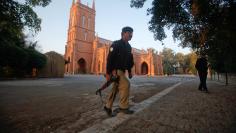 A policeman keeps guard outside St. John Cathedral Church ahead of the Christmas celebrations in Peshawar