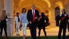 U.S. President Donald Trump and First Lady Melania Trump greet a marching band as they arrive at Trump International Golf club to watch the Super Bowl LI between New England Patriots and Atlanta Falcons in West Palm Beach, Florida, U.S.,  February 5, 2017