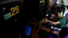 FILE PHOTO: Men use computers at an internet cafe in Bim Son town, outside Hanoi, Vietnam May 15, 2017. REUTERS/Kham 