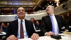 Martin Blessing (R), CEO of Germany's second largest business bank, Commerzbank AG and European Central Bank (ECB) President Mario Draghi react before the start of the the European Banking Congress in the Old Opera house in Frankfurt, November 21, 2014. R