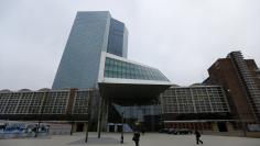 People walk past the new ECB headquarters in Frankfurt December 4, 2014.   REUTERS/Kai Pfaffenbach