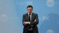 File photo of Tesla Chief Executive Elon Musk standing on the podium as he attends a forum on startups in Hong Kong