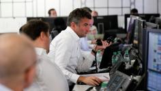 A broker looks at his computer screen on the dealing floor at ICAP in London