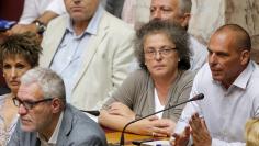 Greek former Finance Minister Yanis Varoufakis (R) sits among lawmakers as he attends a parliamentary session in Athens, Greece, August 14, 2015. REUTERS/Christian Hartmann 