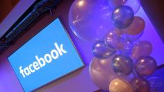 FILE PHOTO: Balloons are seen in front of a logo at Facebook's headquarters in London, Britain, December 4, 2017. REUTERS/Toby Melville/File Photo 