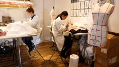 Seamstresses work at the Maison Julien Fournie workshop in Paris