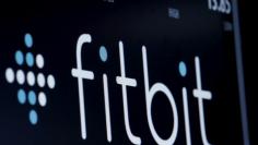 FILE PHOTO: The ticker symbol for Fitbit is displayed at the post where it is traded on the floor of the New York Stock Exchange (NYSE) in New York, U.S., February 23, 2016. REUTERS/Brendan McDermid/File Photo  