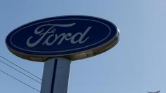 FILE PHOTO: An airplane flies above a Ford logo in Colma, California, U.S., October 3, 2017. REUTERS/Stephen Lam/File Photo 