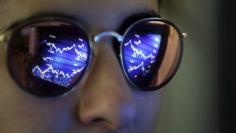 A computer screen showing stock graphs is reflected on glasses in this illustration photo taken in Bordeaux, France, March 30, 2016. REUTERS/Regis Duvignau 