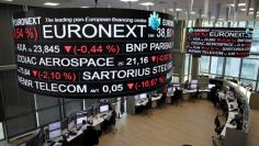 FILE PHOTO: Company stock price information is displayed on screens as they hang above the Paris stock exchange, operated by Euronext NV, in La Defense business district in Paris, France, December 14, 2016. REUTERS/Benoit Tessier 