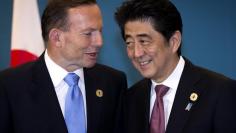 Australia's then Prime Minister Tony Abbott speaks with Japan's Prime Minister Shinzo Abe during a trilateral meeting with U.S. President Barack Obama (not pictured) at the G20 leaders summit in Brisbane November 16, 2014. REUTERS/Ian Waldie/pool  