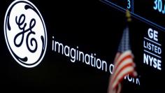 FILE PHOTO - The ticker and logo for General Electric Co. is displayed on a screen at the post where it is traded on the floor of the New York Stock Exchange (NYSE) in New York City, U.S. on June 30, 2016.  REUTERS/Brendan McDermid/File Photo