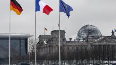 FILE PHOTO - A German, French and an EU flag flutter over the German lower house of parliament in Berlin  January 22, 2013. REUTERS/Fabrizio Bensch 