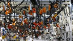 Various tools are seen hanging from the ceiling at the engine manufacturing unit for the new Mercedes AMG GT super sports cars during a factory tour for journalists at the Mercedes AMG headquarters in Affalterbach near Stuttgart, September 9, 2014.  REUTE