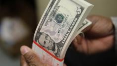 FILE PHOTO: A packet  of former U.S. President Abraham Lincoln five-dollar bill currency is inspected at the Bureau of Engraving and Printing in Washington March 26, 2015. REUTERS/Gary Cameron/File Photo