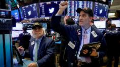 FILE PHOTO: Traders react at the closing bell on the floor of the New York Stock Exchange, (NYSE)  in New York, U.S., November 30, 2017. REUTERS/Brendan McDermid/File Photo