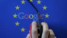 A woman hovers a mouse over the Google and European Union logos in this April 15, 2015 photo illustration.  REUTERS/Dado Ruvic/Illustration/File Photo  