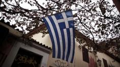 A Greek national flag flutters in the wind at the Plaka district in Athens November 7, 2014. REUTERS/Alkis Konstantinidis  