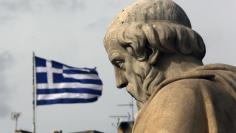 A Greek flag flutters above the statue of Greek philosopher Plato outside the Athens Academy, February 2, 2015 REUTERS/Yannis Behrakis 