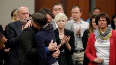 Victim Rachael Denhollander is embraced by her husband Jacob after she spoke at the sentencing hearing for Larry Nassar, a former team USA Gymnastics doctor who pleaded guilty in November 2017 to sexual assault charges, in Lansing, Michigan, U.S., Januar