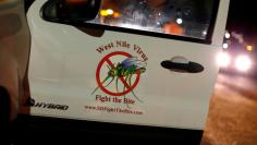 A vector control team vehicle displays a sign warning of West Nile Virus before the early morning spraying of a neighborhood due to increasing numbers of mosquitoes having tested positive for West Nile virus in San Diego, California, U.S. May 18, 2016.  R
