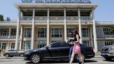 FILE PHOTO: People walk past a branch of China Minsheng Bank in Beijing, June 27, 2013. REUTERS/Jason Lee/File Photo