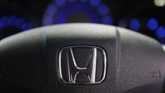 The logo of Honda Motor Co is seen on a steering wheel of a car at the company's showroom in Tokyo April 26, 2013. REUTERS/Yuya Shino
