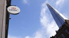 An HSBC sign is seen outside a bank branch near the Shard in London February 9, 2015.  REUTERS/Suzanne Plunkett 