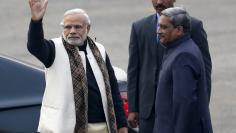 India's Prime Minister Narendra Modi (L) waves next to Defence Minister Manohar Parrikar (R) upon his arrival at the "Beating the Retreat" ceremony in New Delhi, India, January 29, 2016.  REUTERS/Altaf Hussain