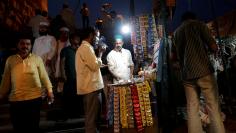 FILE PHOTO: Man lights a cigarette at a roadside stall in old quarters of Delhi