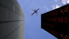 FILE PHOTO - A plane flys above an electronic board displaying market data outiside the Tel Aviv Stock Exchange, in Tel Aviv, Israel January 29, 2017. REUTERS/Baz Ratner 