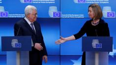 European High Representative for Foreign Affairs Federica Mogherini shakes hands with Palestinian President Mahmoud Abbas in Brussels