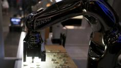 FILE PHOTO : Denso Corp's robot arm "Denoute-san" plays Japanese chess, also known as Shogi, at a booth during Niconico Chokaigi 2015 in Makuhari