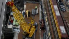 Heavy machineries are seen next to a subway train at a construction site in Tokyo, Japan, March 13, 2016. REUTERS/Yuya Shino 