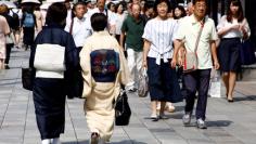 FILE PHOTO: Women in traditional costume 'Kimono' make their way at a shopping district in Tokyo, Japan August 21, 2017. REUTERS/Kim Kyung-Hoon/File Photo 