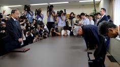 FILE PHOTO: Kobe Steel President and CEO Kawasaki bows as he meets with Ministry of Economy, Trade and Industry's Director-General of Manufacturing Industries Bureau, Tada at the ministry in Tokyo