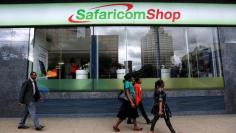 Pedestrians walk past a mobile phone care centre operated by Kenyan's telecom operator Safaricom in the central business district of Kenya's capital Nairobi, May 11, 2016. REUTERS/Thomas Mukoya