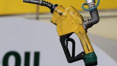 A gas pump is seen hanging from the ceiling at a petrol station in Seoul June 27, 2011.  REUTERS/Jo Yong-Hak 