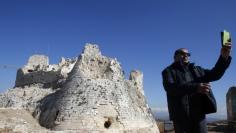 A man takes a selfie in front of the newly restored Crusader Beaufort castle in Arnoun village, south Lebanon January 18, 2015. REUTERS/Ali Hashisho