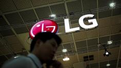 A man talking on his phone walks past the logo of LG Electronics during Korea Electronics Show 2016 in Seoul, South Korea, October 27, 2016.  REUTERS/Kim Hong-Ji 