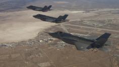 Three F-35 Joint Strike Fighters (rear to front) AF-2, AF-3 and AF-4, can be seen flying over Edwards Air Force Base in this December 10, 2011 handout photo provided by Lockheed Martin. REUTERS/Lockheed Martin/Darin Russell/Handout 