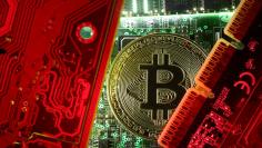 FILE PHOTO: A coin representing the bitcoin cryptocurrency is seen on computer circuit boards in this illustration picture, October 26, 2017. REUTERS/Dado Ruvic/File Photo