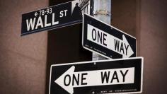 A 'Wall St' sign is seen above two 'One Way' signs in New York August 24, 2015.   REUTERS/Lucas Jackson