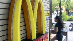 A girl runs past a McDonald's store in Taipei