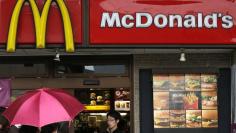Passersby walk past a McDonald's store in Tokyo