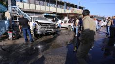 Iraqi security forces gather at the site of a bomb attack in the city of Kerbala, Iraq June 9, 2017.  REUTERS/Stringer 