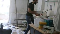 A man removes medicine inside the Medecins Sans Frontieres (MSF)-backed al-Quds hospital after it was hit by airstrikes, in a rebel-held area of Syria's Aleppo, April 28, 2016. REUTERS/Abdalrhman Ismail 